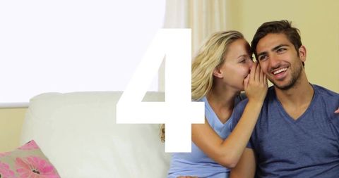 Whispering Couple Sharing Secret on Sunlit Sofa, Intimate Laughing Moment for Lifestyle Use