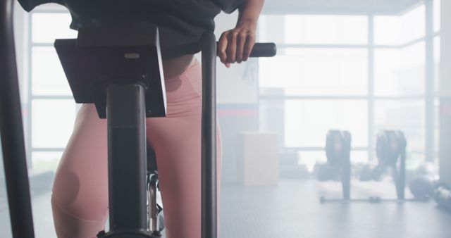 Woman Stationary Biking in Modern Gym Setting - Download Free Stock Images Pikwizard.com