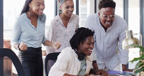 Team Celebrating Success at Modern Office with Joyful Expressions