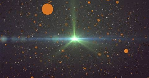 Green starburst with blue-green lens flare and orange bokeh orbs in deep space