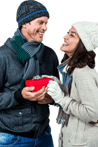 Festive Winter Couple Exchanging Romantic Gift Laughing Together