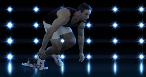 Athlete preparing to sprint under shimmering lights