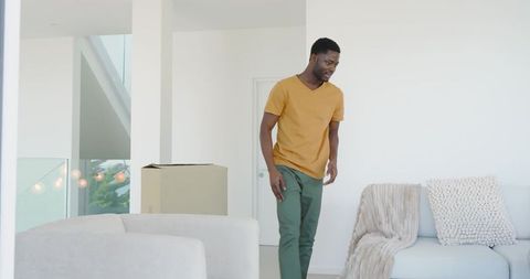 Man Unpacking in Minimalist Home Living Room