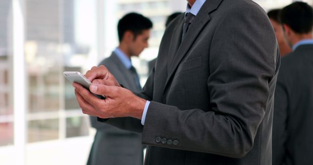 Businessman Using Smartphone in Office Setting - Download Free Stock Images Pikwizard.com