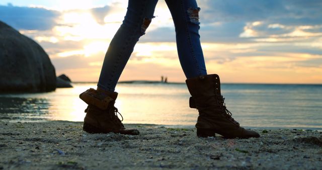 Person Walking on Beach at Sunset with Stylish Boots - Download Free Stock Images Pikwizard.com