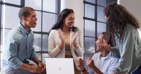 Diverse Team Celebrating Office Achievement Together