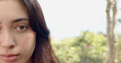Serene Woman in Garden with Soft Sunlight on Profile
