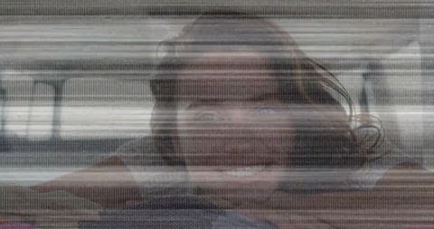 Smiling woman leaning in vehicle with scan-line distortion and moody closeup portrait