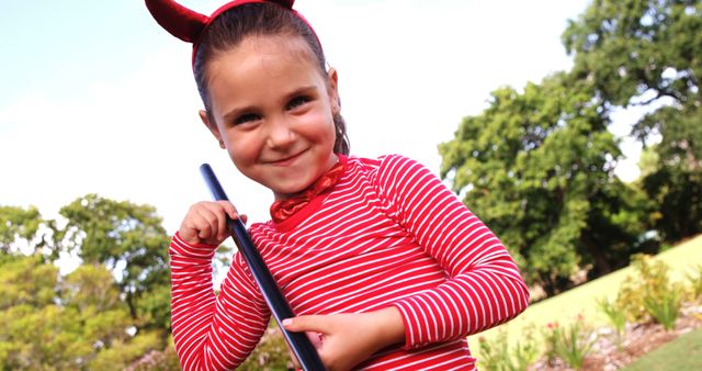 Young Girl in Devil Costume Enjoying Halloween Outdoors - Download Free Stock Images Pikwizard.com