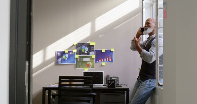 Businessman Making Phone Call in Modern Office With Charts and Graphs on Wall - Download Free Stock Images Pikwizard.com