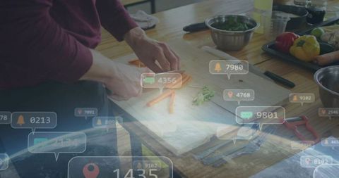 Hands chopping carrots on wooden board in home kitchen with social notification overlays