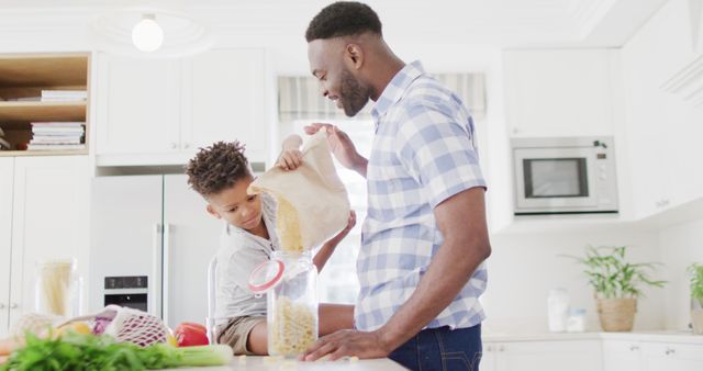 Father and Son Storing Pasta in Kitchen - Download Free Stock Images Pikwizard.com