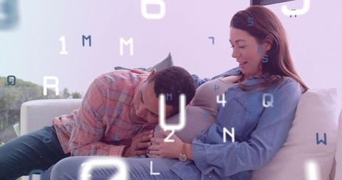 Expecting couple sharing tender moment on sofa with floating letter overlay