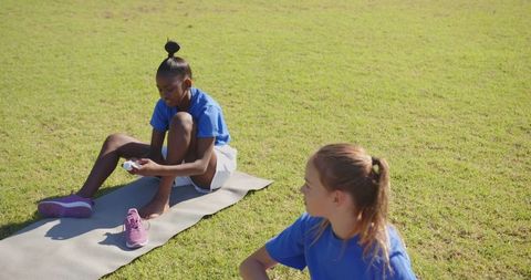 Children Preparing for Outdoor Sports Activity on Field