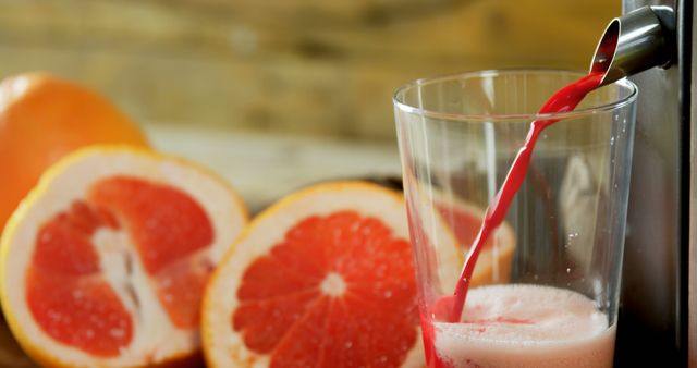 Fresh Grapefruit Juice Pouring Into Glass with Sliced Grapefruits - Download Free Stock Images Pikwizard.com