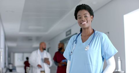 Confident African American Female Doctor Smiling in Hospital Corridor