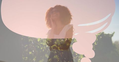Joyful Woman Amid Sunlit Greenery Reflecting Happiness