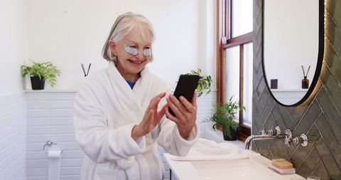 Senior Woman Enjoying Skincare Routine in Modern Bathroom