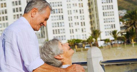 Senior Caucasian Couple Embracing Outdoors on Sunny Day