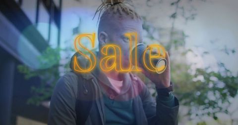 Urban commuter sipping takeaway coffee with neon sale overlay, streetstyle portrait