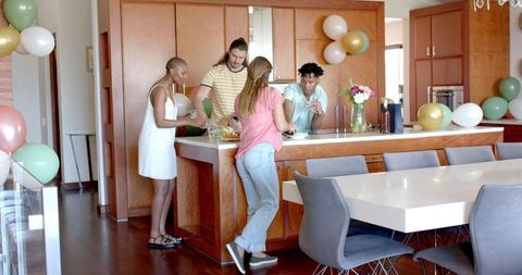 Friends Gathering in Modern Kitchen for Casual Celebration
