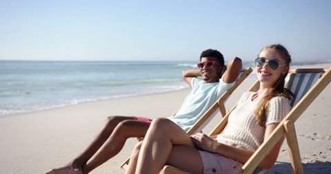 Young Couple Relaxing on Beach Chairs by Sea - Download Free Stock Images Pikwizard.com