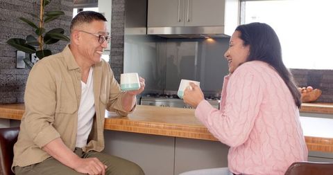 Couple Enjoying Cozy Moment Over Coffee in Modern Kitchen