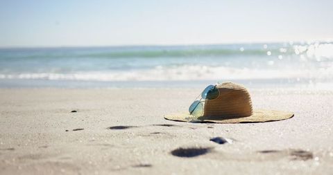 Straw Hat and Sunglasses on Sandy Beach Inspires Relaxation - Download Free Stock Images Pikwizard.com