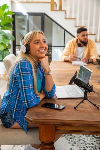 Podcasters engaging in conversation at modern home studio