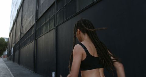 Young Woman Running in Urban Street for Fitness