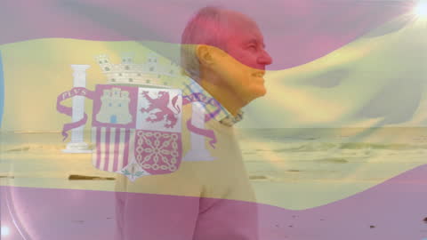 Senior Man Walking on Beach with Spanish Flag Overlay