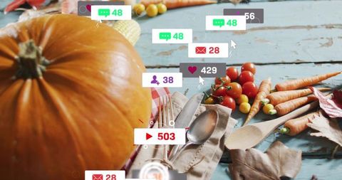 Autumn harvest table with pumpkin, carrots and cutlery with social media notifications