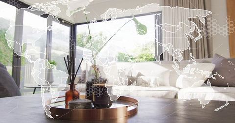 Minimalist modern living room tray with vase and diffuser, daylight world map overlay