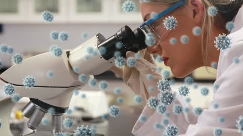Scientist Observing Covid-19 Virus Through Microscope in Laboratory