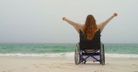 Caucasian Woman in Wheelchair Enjoying Freedom by the Sea