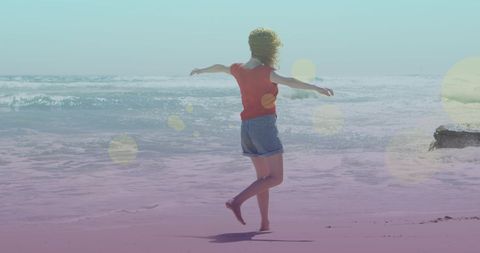 Joyful Woman Walking Freely on Sunny Beach