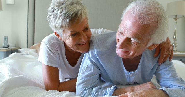 Happy Senior Couple Cuddling on Bed in Bright Bedroom - Download Free Stock Images Pikwizard.com