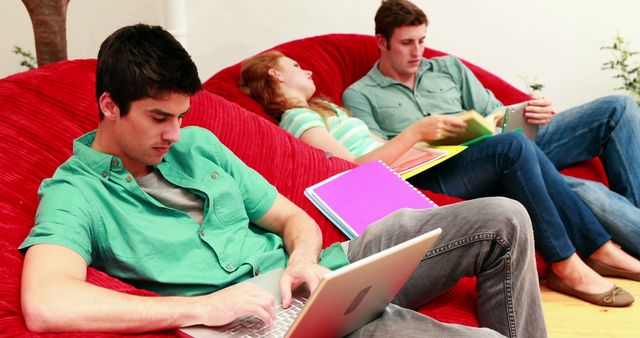 Young Adults Studying and Relaxing on Red Bean Bags - Download Free Stock Images Pikwizard.com