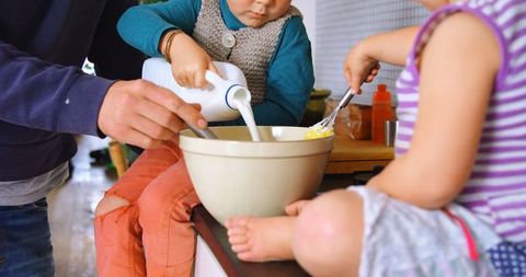Father and Children Cooking Together at Home