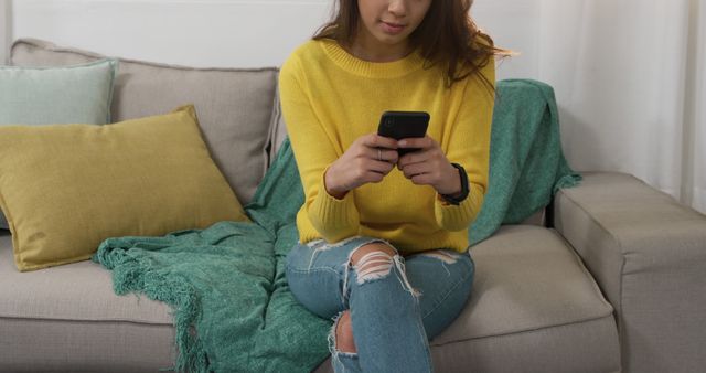 Woman in Yellow Sweater Using Smartphone in Cozy Living Room - Download Free Stock Images Pikwizard.com