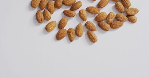 Almonds Scattered on White Surface for Healthy Eating and Vegan Diet - Download Free Stock Images Pikwizard.com