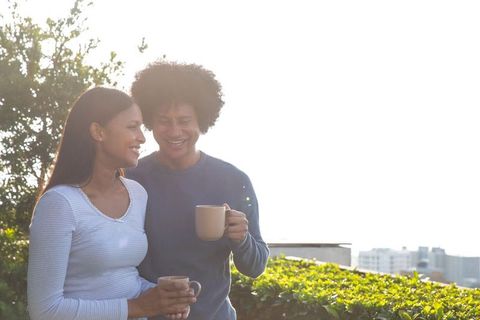 Romantic Couple Enjoying Coffee on Urban Rooftop Terrace