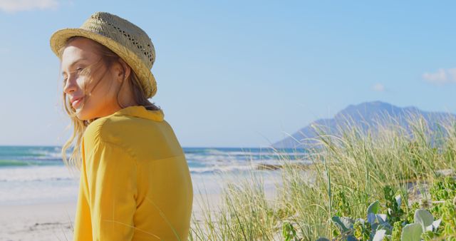 A young Caucasian woman enjoys a serene moment by the beach, with copy space - Download Free Stock Photos Pikwizard.com