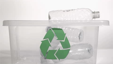 Plastic Bottles Thrown into Recycling Bin in Slow Motion