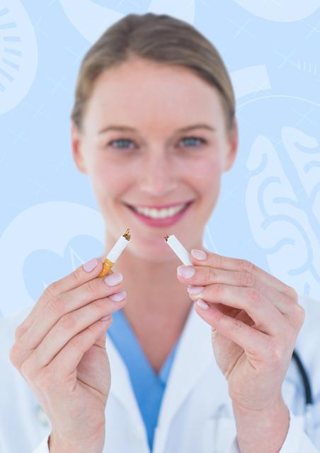 Female doctor smiling while holding broken cigarette, symbolizing anti-smoking message and advocating for a healthy, smoke-free lifestyle. Ideal for use in healthcare campaigns, medical articles, and anti-smoking promotional materials.