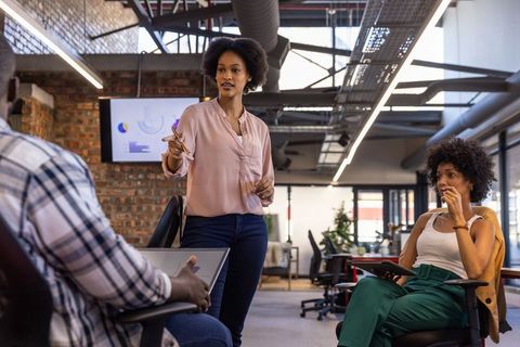 Diverse Team Analyzing Data in Modern Open-Plan Office
