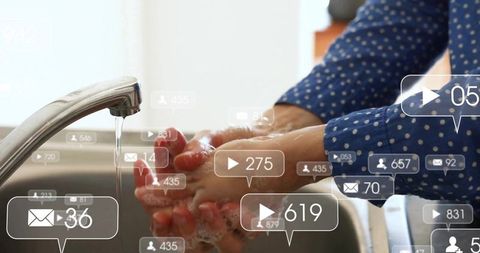 Woman washing hands with soap at kitchen sink with digital social media overlay icons