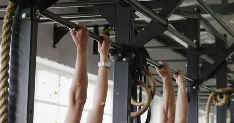 Man and woman gripping pull-up bar, starting crossfit set, wearable fitness watch tracking