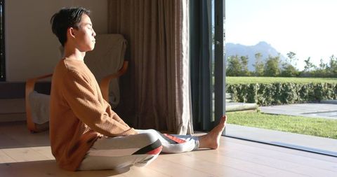 Young Man Enjoying Peaceful Moment by Panoramic Mountain View