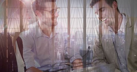 Coworkers collaborating in modern glass office environment